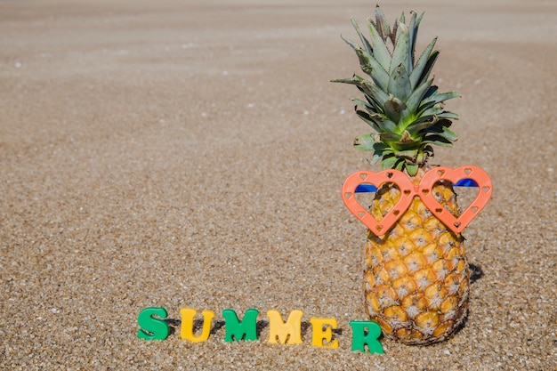 Summertime on beach with pineapple