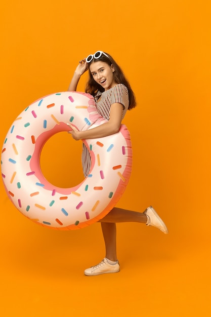 Summertime and holidays concept. Vertical full length image of excited overjoyed young European woman