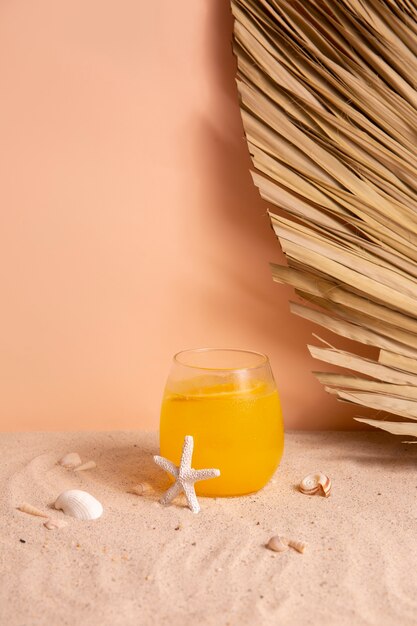 Summertime vibes with sand and orange cocktail