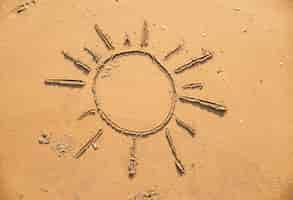 Free photo sun drawn in the sand