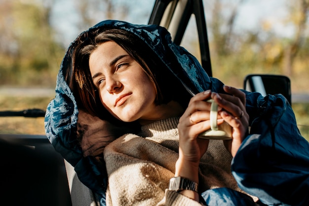 Sun-kissed woman holding a cup of coffee