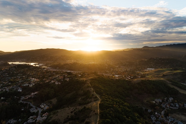 Sun rising over a mountainous scenery in the countryside