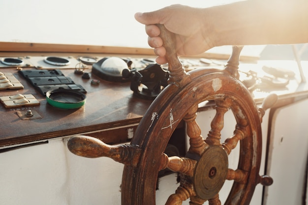 Free photo sun shines over the wooden wheel held by man