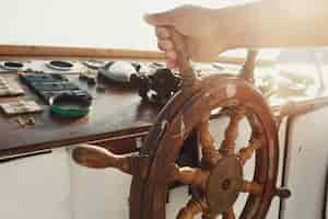 Free photo sun shines over the wooden wheel held by man