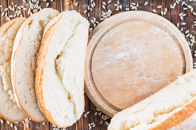 Sunflower seeds and baked bread slices over the wooden table