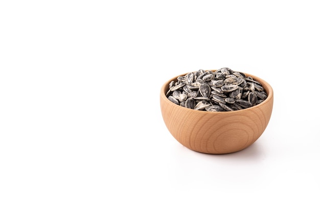 Sunflower seeds in wooden bowl isolated on white background Copy space