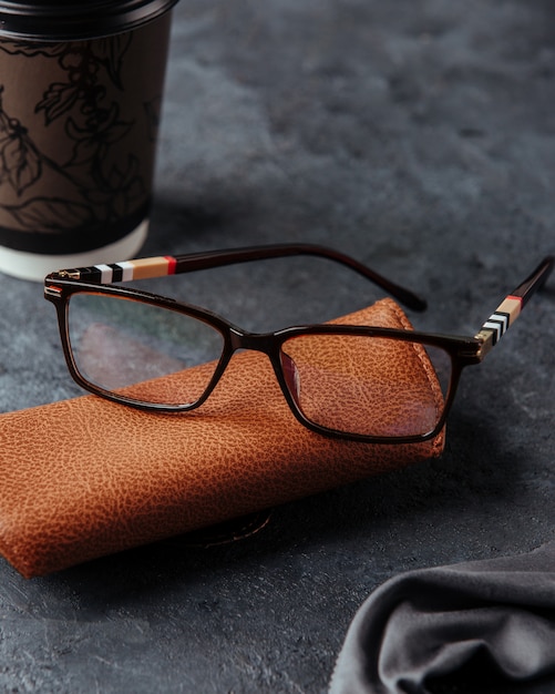 Sunglasses on the brown case and grey surface