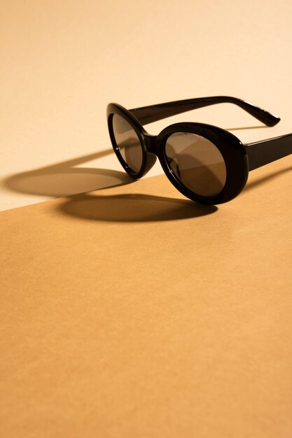 Sunglasses on a table with shadow