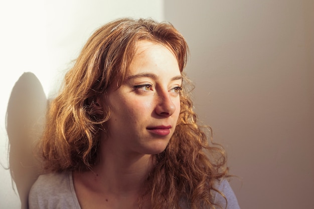 Sunlight falling over serene young woman' s face