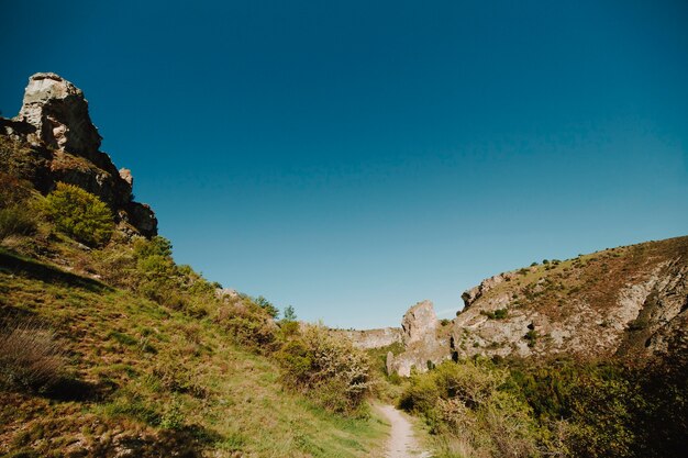 Sunny rocky landscape with vegetation