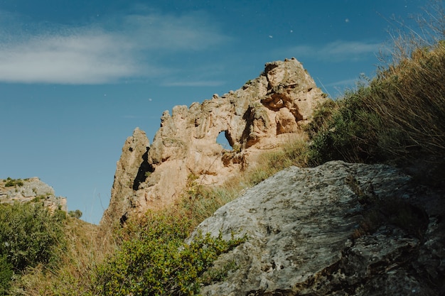 Sunny rocky landscape with vegetation