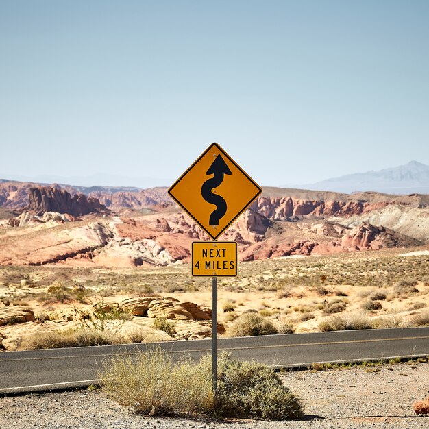 Sunny scenery of a yellow traffic signpost in the Valley of Fire State Park in Nevada, USA