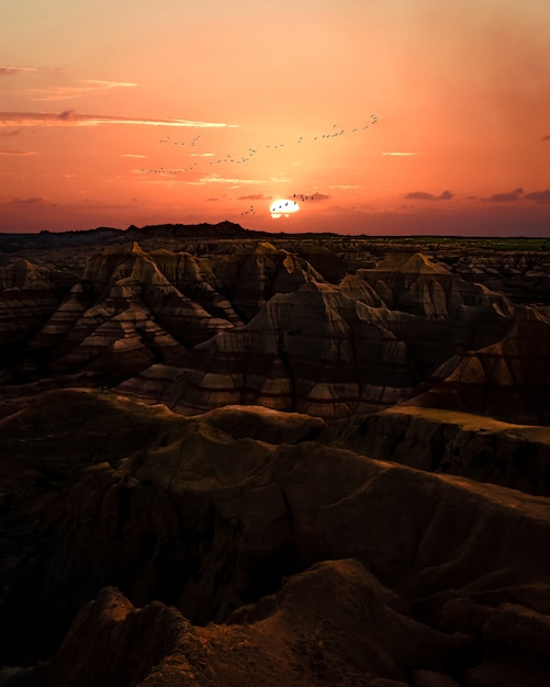 Sunset over badlands. terrain with striped rock formations