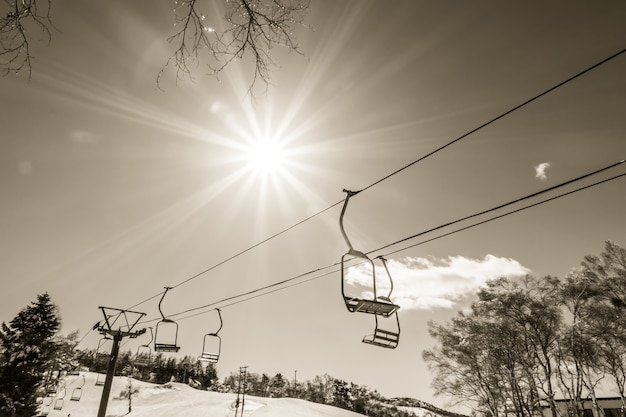 Sunset and  Ski lift going over the mountain ( Filtered image pr