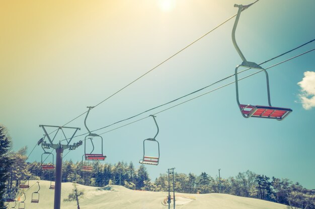 Sunset and  Ski lift going over the mountain ( Filtered image pr
