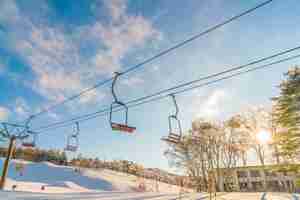 Free photo sunset and  ski lift going over the mountain