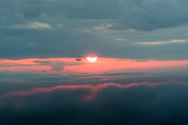 Sunset with a red sun and clouds