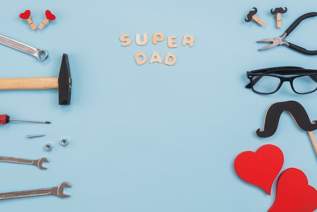 Free photo super dad inscription with tools and glasses