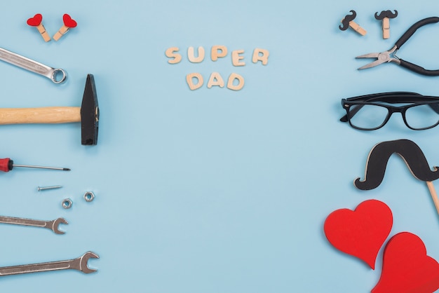 Super dad inscription with tools and glasses 