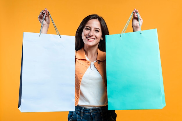 Super excited woman holding up shopping bags
