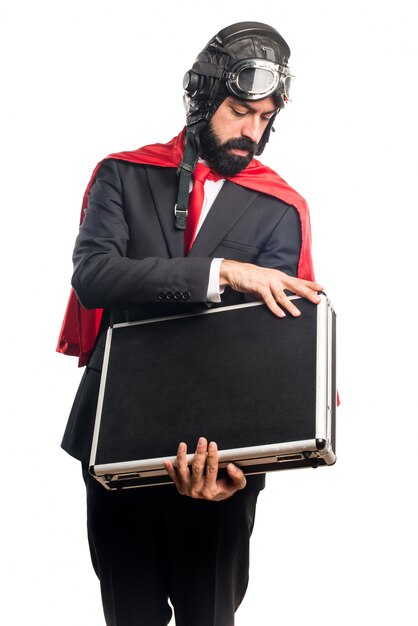 Super hero businessman holding a briefcase