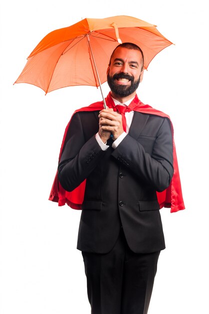 Super hero businessman holding an umbrella