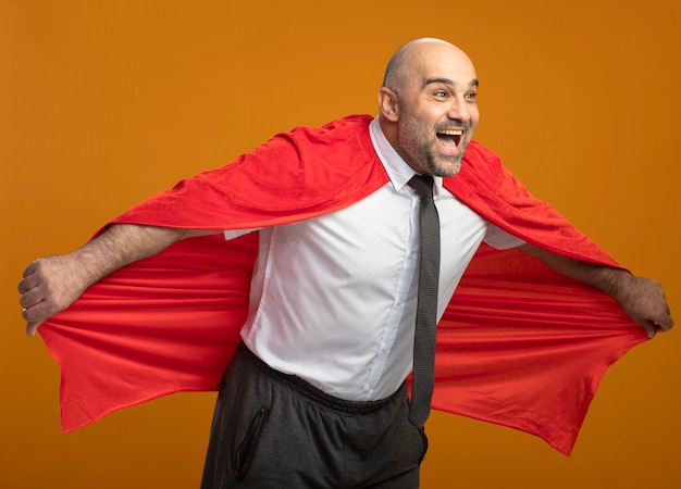 Super hero businessman in red cape happy and positive going to fly holding his cape 