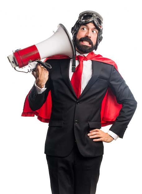 Super hero businessman shouting by megaphone