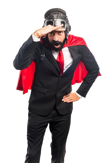 Super hero businessman showing something