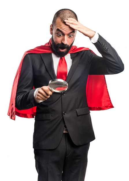 Super hero businessman with magnifying glass