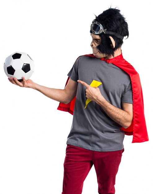 Superhero monkey man holding a soccer ball