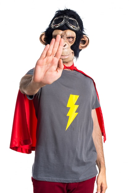 Superhero monkey man making stop sign