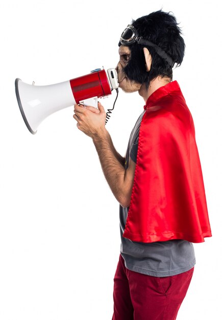 Superhero monkey man shouting by megaphone