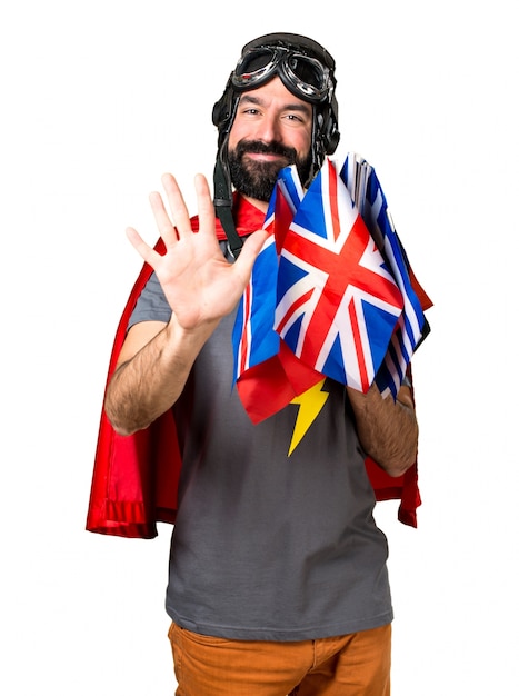 Free photo superhero with a lot of flags counting five