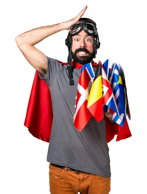 Free photo superhero with a lot of flags having doubts