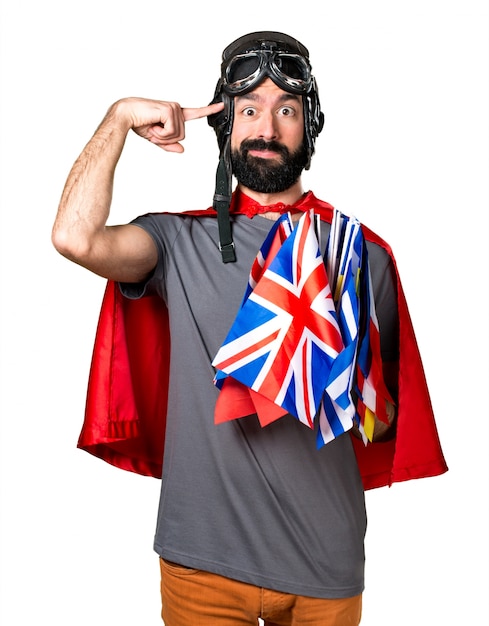 Free photo superhero with a lot of flags making crazy gesture