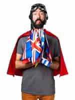 Free photo superhero with a lot of flags making a joke