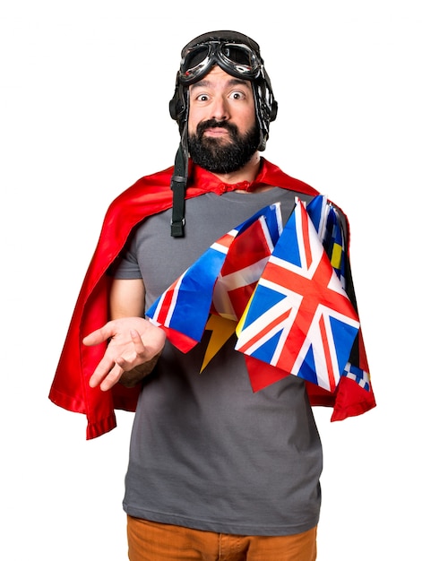 Superhero with a lot of flags making surprise gesture