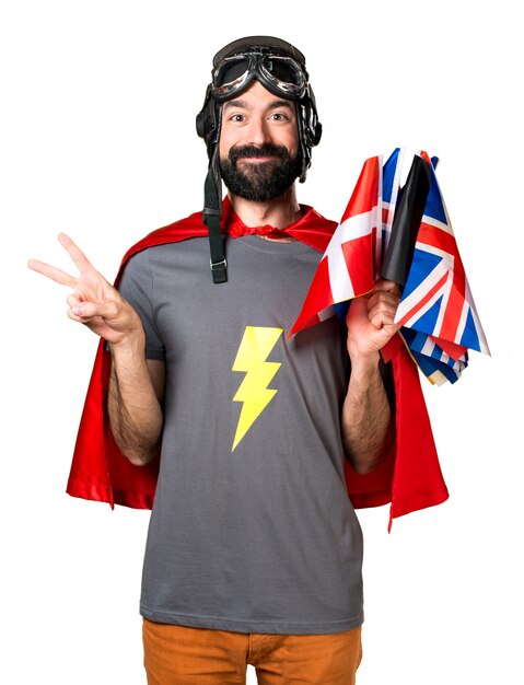 Superhero with a lot of flags making victory gesture