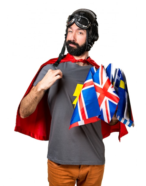 Free photo superhero with a lot of flags proud of himself