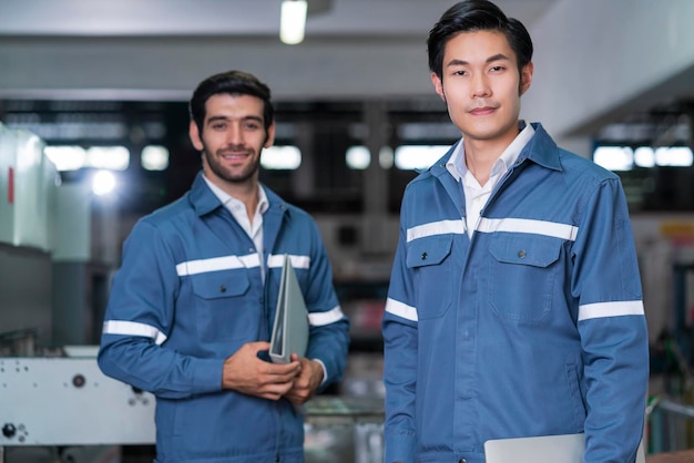 Supervisor manager male engineer worker wears uniform working hand use laptop stock checking in store warehouse shipping industrial team with safety uniform checking quantity of product on shelf