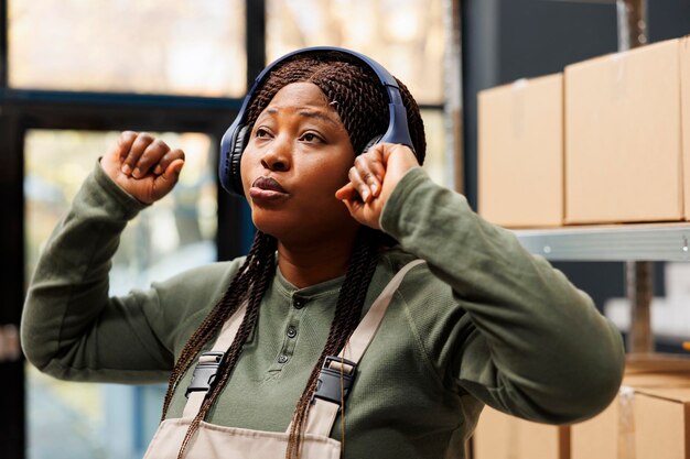 Free photo supervisor with headphones dancing and having fun