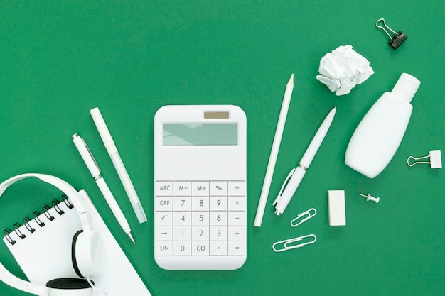 Supplies for school on green background