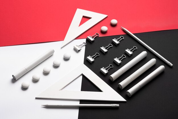 Supplies on white red and black table