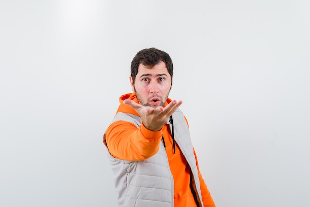 The suprised man is holding up his hand on white background