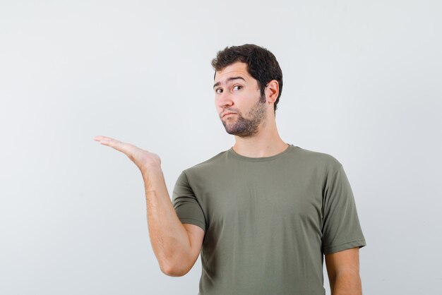 The suprised man is pointing to left with hand on white background