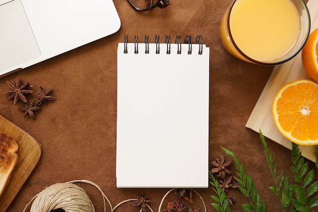 Surface with orange juice and blank notebook for father's day