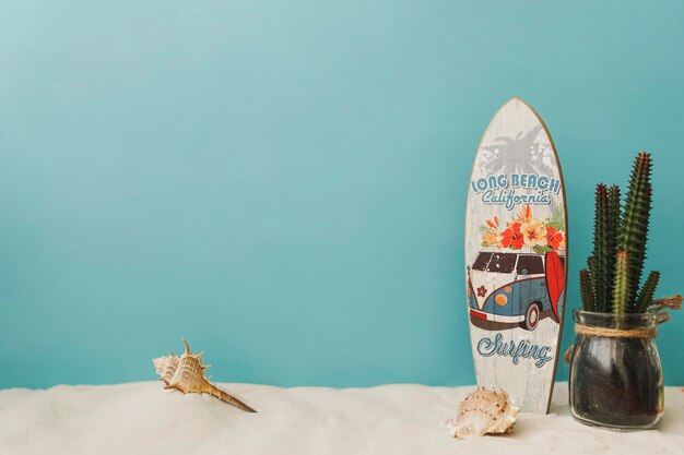 Surfboard and cactus on blue background