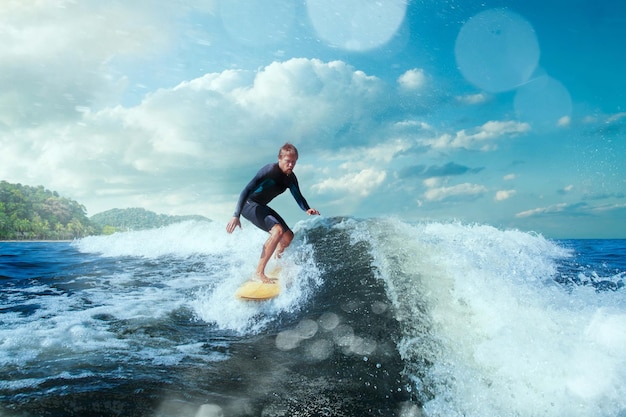 Surfer on Blue Ocean Wave Getting Barreled