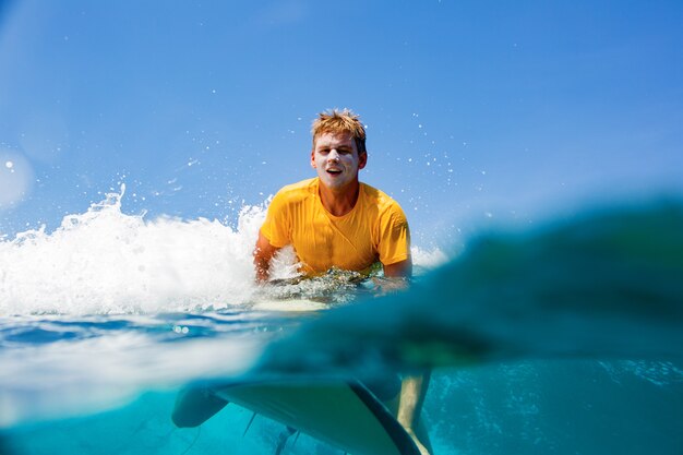 Surfer on a blue wave.